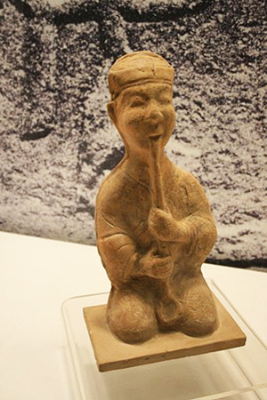 Ceramic figurine of a 'xiao' vertical flute player