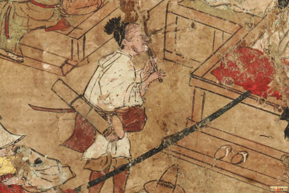 Komosō playing the hitoyogiri in a street, close-up